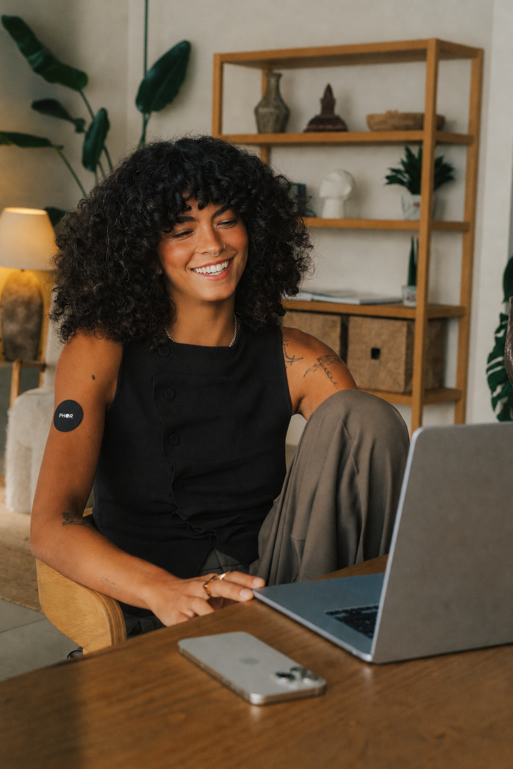 Woman wearing the PHOR patch while working